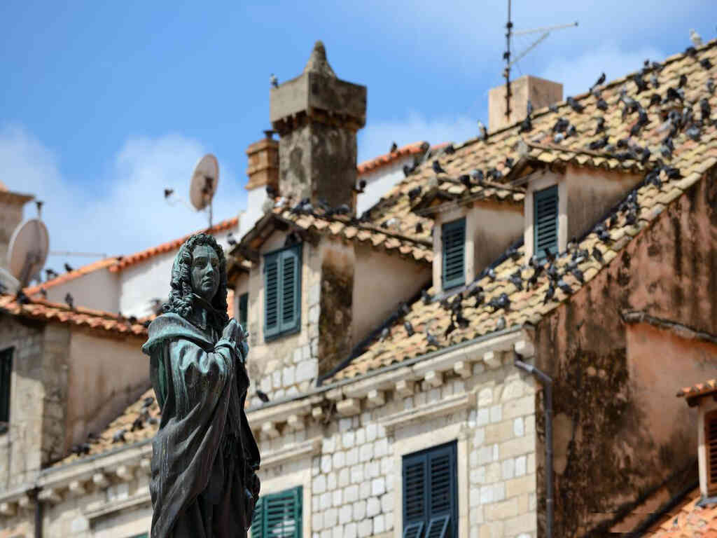 Ivan Gundulić statue and historic rooftops at Gundulić Square in Dubrovnik